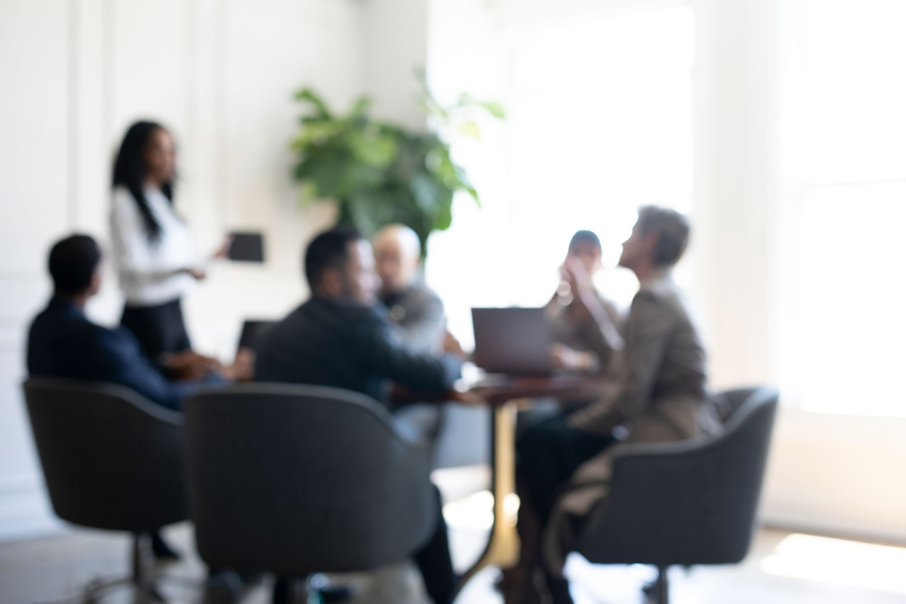 People meeting in conference room blurred