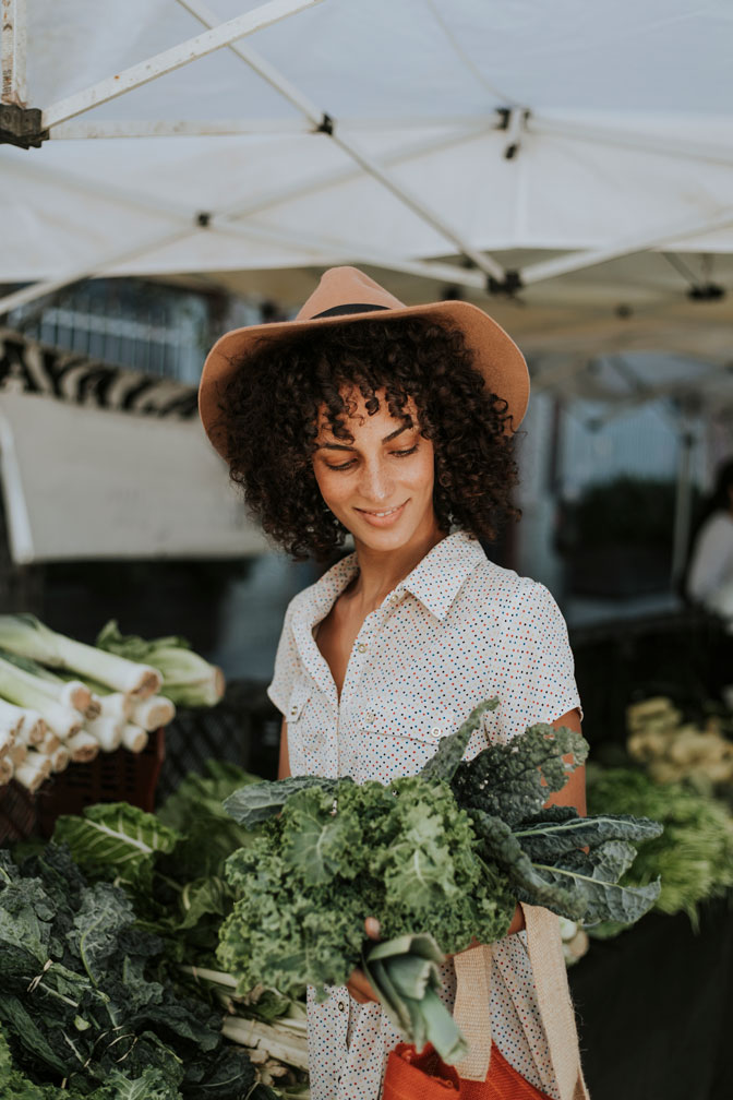 Woman buying lettuce at market